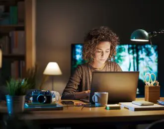 Young woman working on her laptop at home