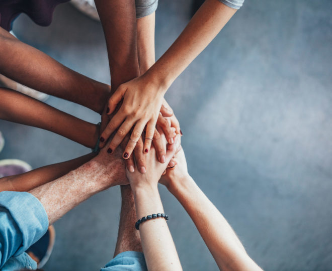 Stack of hands showing unity