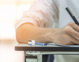 School exam student’s taking educational admission test in class